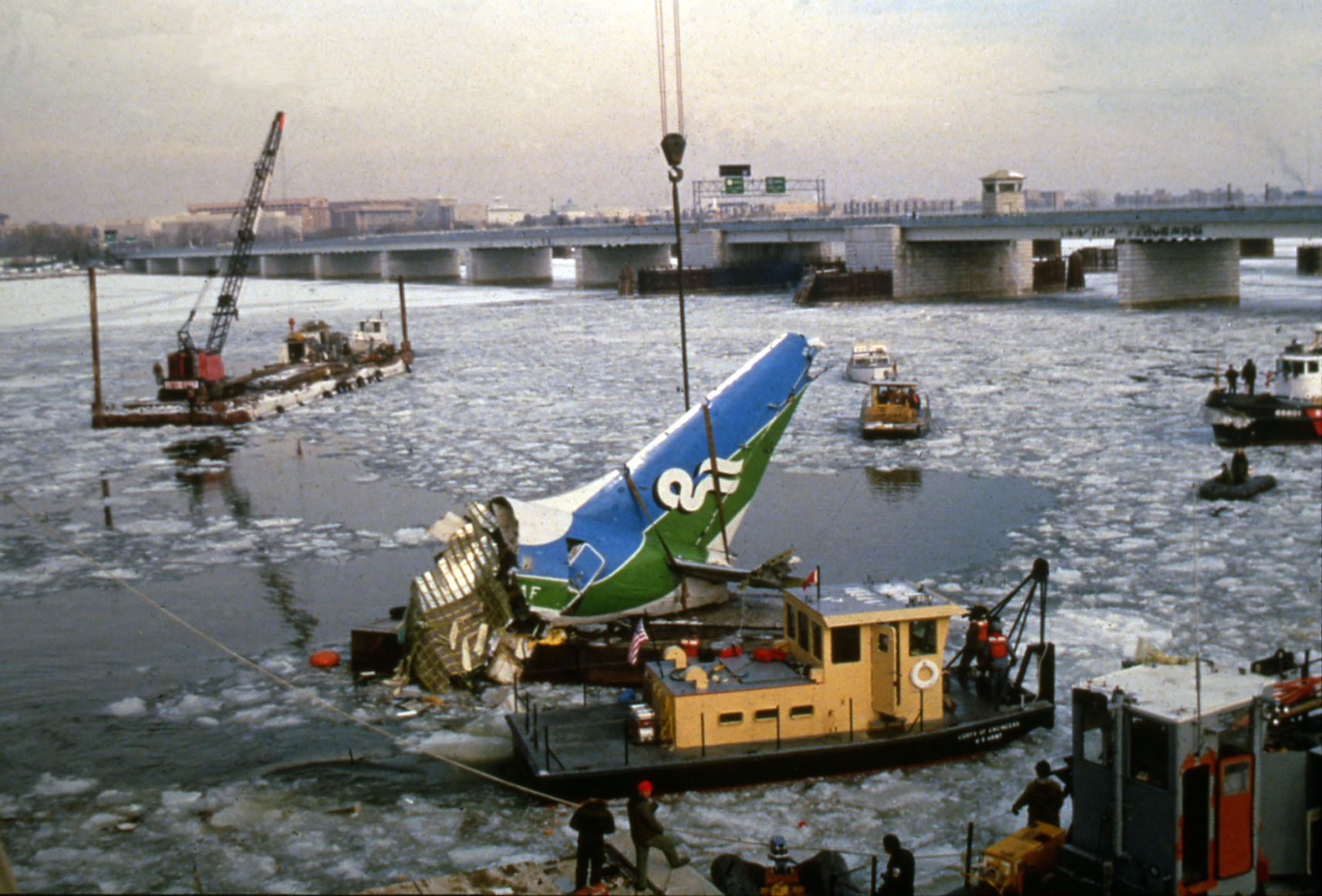 Boats and plane wreckage in icy river water